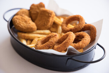 fried onions, chicken and potatoes on a plate