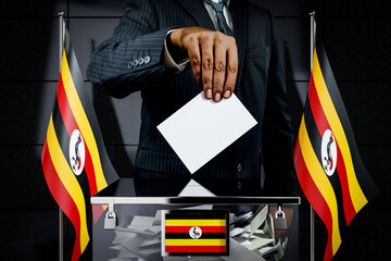 Uganda flags, hand dropping voting card - election concept - 3D illustration