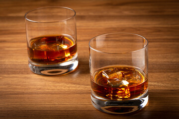 Glass with whiskey and ice cubes.