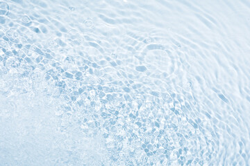 Blue background with circles from drops, water splashes and blurred waves, great creative design, top view