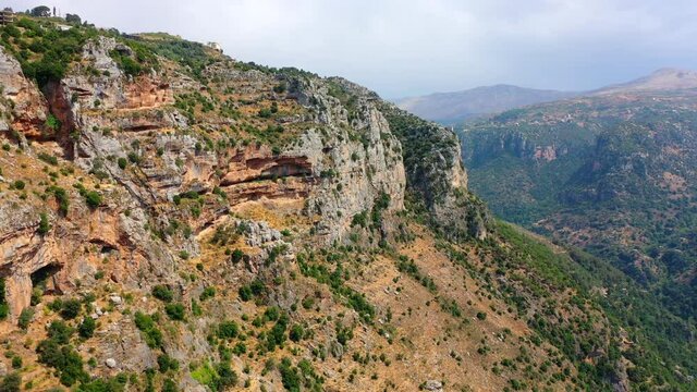 Aerial Scenic Shot Of Built Structures On Mountain Top, Drone Flying Backwards Over Plants - Bsharri, Lebanon