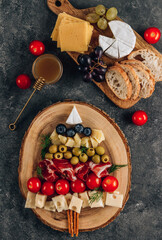 Christmas snack tree on dark concrete background. Cheese plate. Christmas food concept. Top view