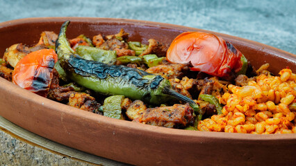 Close up of Turkish chicken Kebab called Mudurnu Kebab, garnished with vegetables, bulgur pilaf served on ceramic dish - Turkish,  Food Kebab