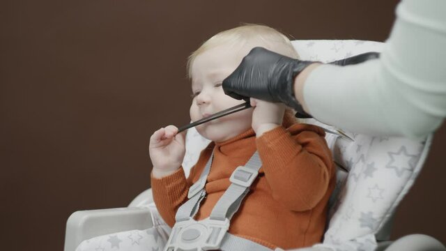 the process of the first haircut of a one-year-old baby's hair