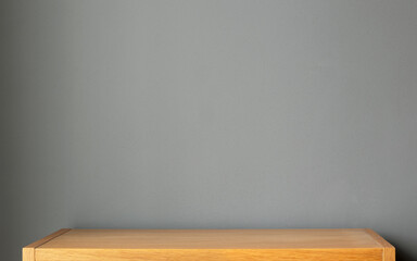 wooden shelf and grey wall