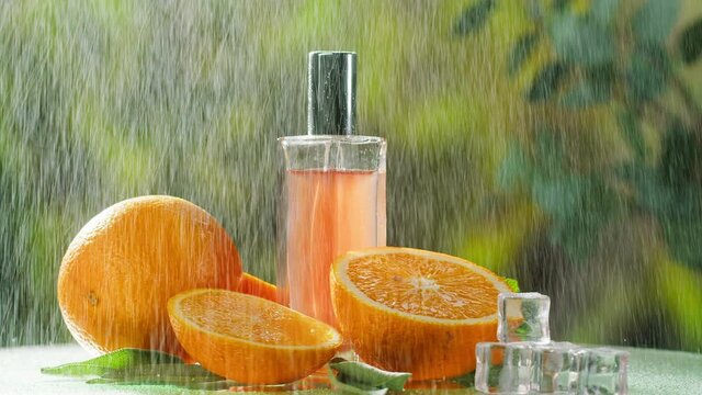 Aroma oil close-up. Spray diffuser and oranges on nature background. Perfume for home, relaxing and spa treatments. Skincare, cosmetics and beauty concept. 