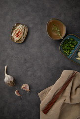 Fototapeta na wymiar Background with spices on plates and chopsticks