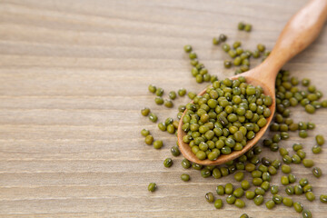 mung bean in wood spoon on wood table