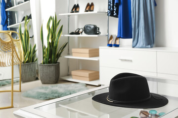 Trendy felt hat on table in boutique