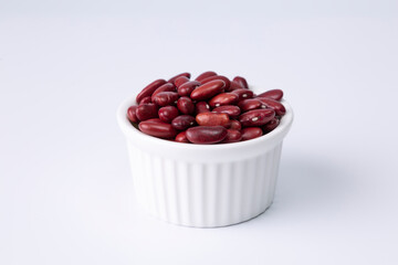 red kidney bean in white bowl on white background studio shot