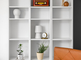 Fototapeta na wymiar Modern shelf unit with decor in room