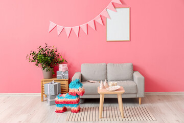Interior of stylish living room with sofa and Mexican pinata decorated for Birthday party