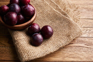 Obraz premium plums fruits natural products on a wooden table top view