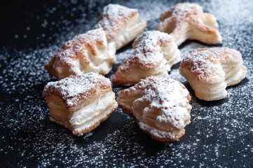 Christmas puff pastry cookies on a black slate background