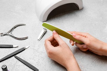 Woman doing manicure on light table
