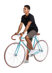 African-American teenage boy riding bicycle on white background