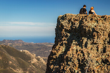 Hikers overlook Malibu and the Pacific Ocean in Malibu Creek State Park, California