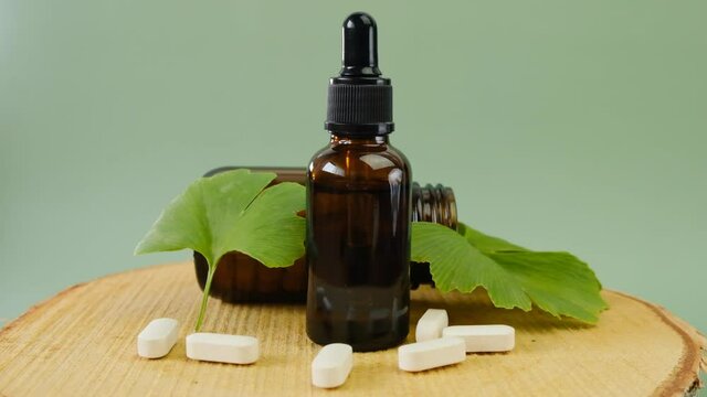 Ginkgo biloba extract in tablets and liquid extract of ginkgo biloba. 4k footage