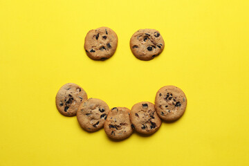 Composition with tasty homemade cookies on yellow background