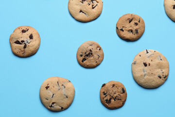 Tasty homemade cookies with chocolate chips on blue background