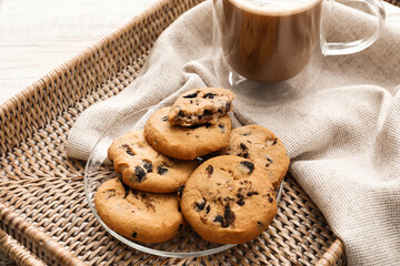 Tray with tasty homemade cookies and glass cup of coffee on table