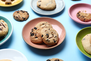 Plates with tasty homemade cookies on blue background