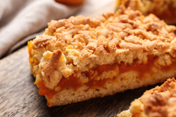 Pieces of tasty pumpkin pie on table, closeup
