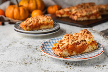 Plates with pieces of fresh pumpkin pie on table