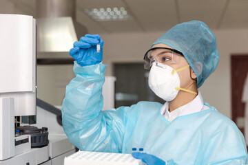 Female scientist looking at the scientific sample in the CDC laboratory.	