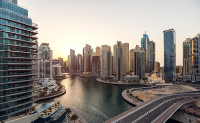 Fototapeta na wymiar Cityscape and skyscraper at sunset in Dubai Marina.