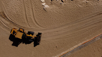 Excavator driving on beach. Top down view. Mar del Plata Beach © Santiago