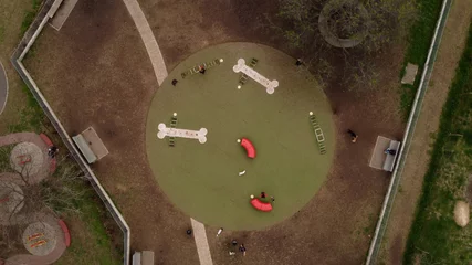 Papier Peint photo autocollant Buenos Aires Aerial top down shot of circular dog park having fun in nature