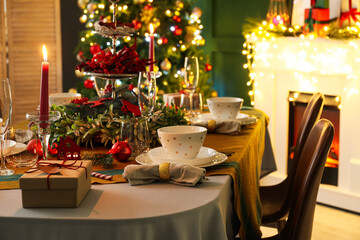Dining table with beautiful setting in living room decorated for Christmas eve