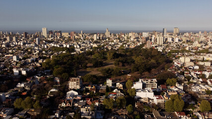 Aerial shot of idyllic Saavedra Park surrounded by giant skyscraper city of Buenos Aires during...