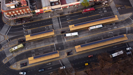 Aerial top down shot of arriving bus at Chacarita Bus Station in Buenos Aires and driving cars on...