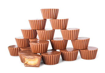 Tasty peanut butter cups on white background