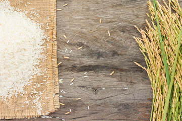 Organic rice or jasmine rice on a wooden floor, top view