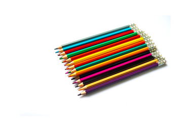 Color pencils on white background.Set of wooden color pencils arranged in bulk with copy space.Photo select focus.