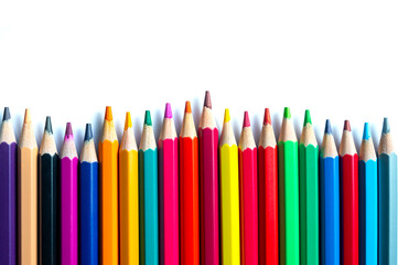 Color pencils on white background.Set of wooden color pencils arranged in bulk with copy space.Photo select focus.