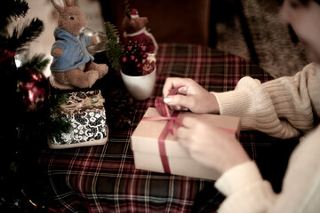 young woman wrapping a gift box