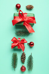 Composition with Christmas gifts, fir branches and decorations on color background