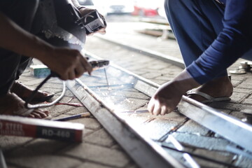 a construction worker is welding iron for a building