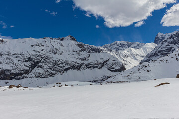 Fototapeta na wymiar Winter season. Snowed mountains in La Egorda Valley, Cajón del Maipo, central Andes mountain range, Chile