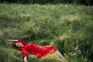 woman in a black dress lies in a field nature fashion summer