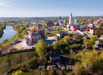 Scenic cityscape of Belyov town located on Oka river overlooking residential areas and church steeples in sunny spring day, Russia..