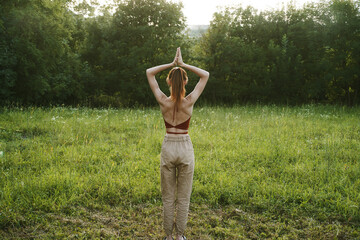 woman in a field outdoors summer meditation fresh air