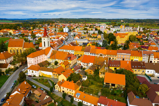 Aerial view of historical centre of Blatna in autumn day overlooking bell tower of gothic church of Assumption of Mary, Czech Republic