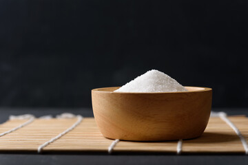 White granulated sugar on black background