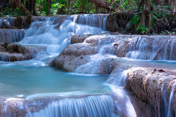 Obraz premium Erawan waterfalls in the national park mountains of Kanchanaburi BKK Bangkok Thailand lovely turquoise blue creamy waters lush green trees smooth rock formations