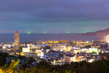 night sunset view of Patong and patong beach with the buildings and high-rise hotels and resorts in the background Kathu phuket Thailand 